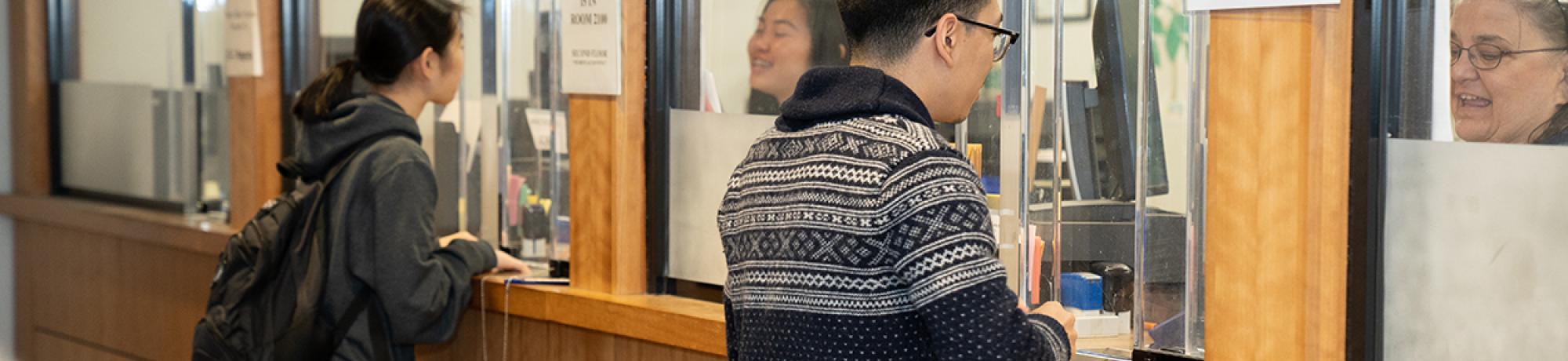 students at the cashier's office teller window